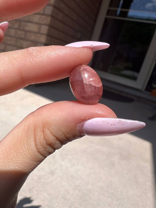 Oval rhodochrosite cabochon